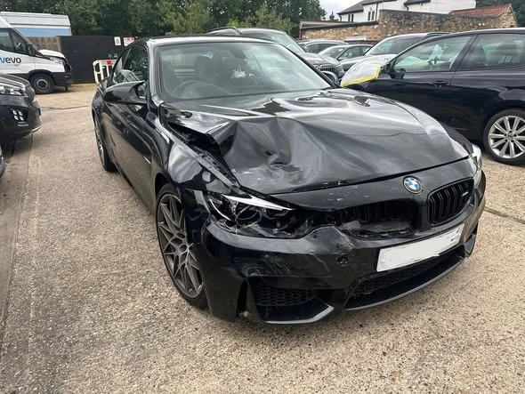 Black BMW M4 before repair